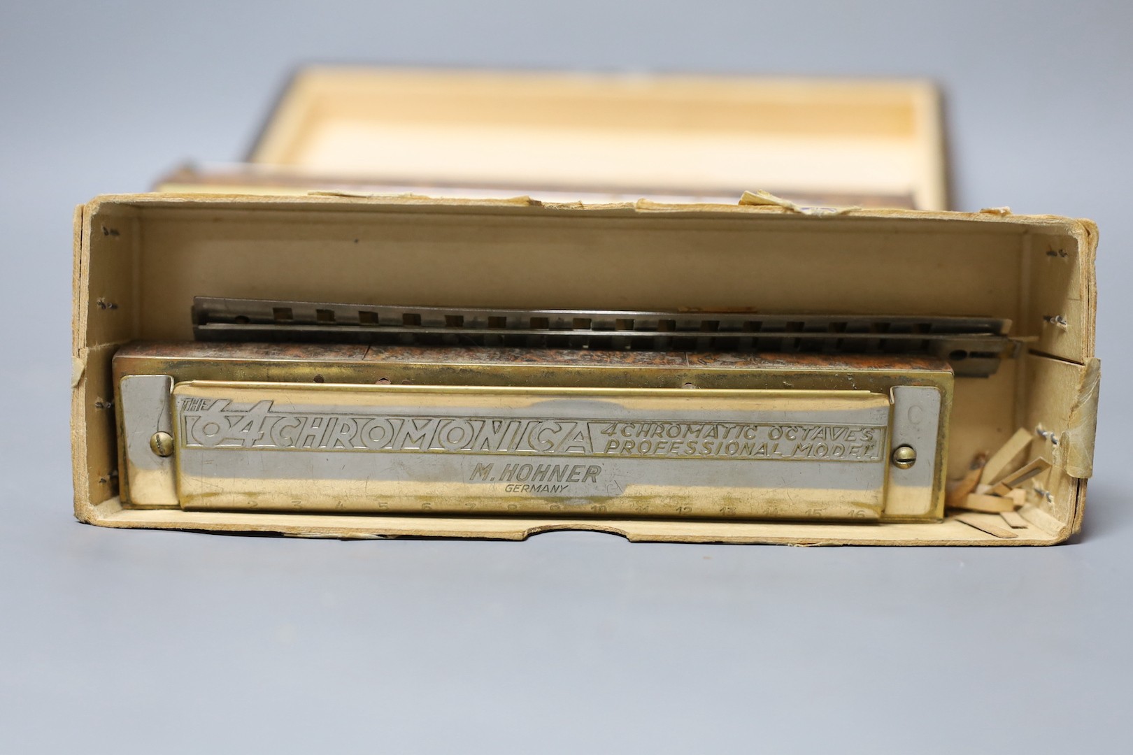 Three cased Hohner harmonicas including a chronomatica no.265